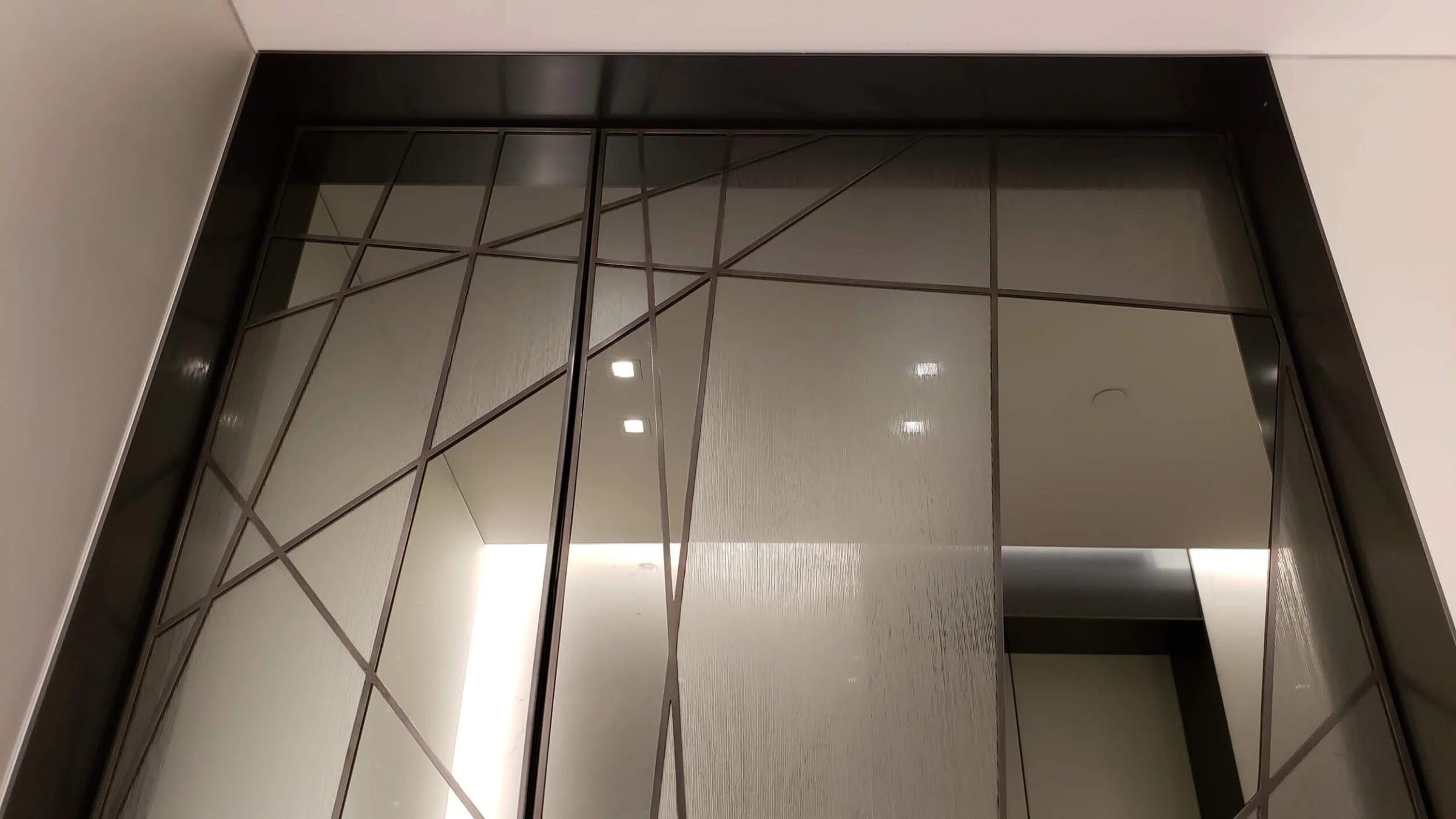 Angled mullion pattern above a doorway