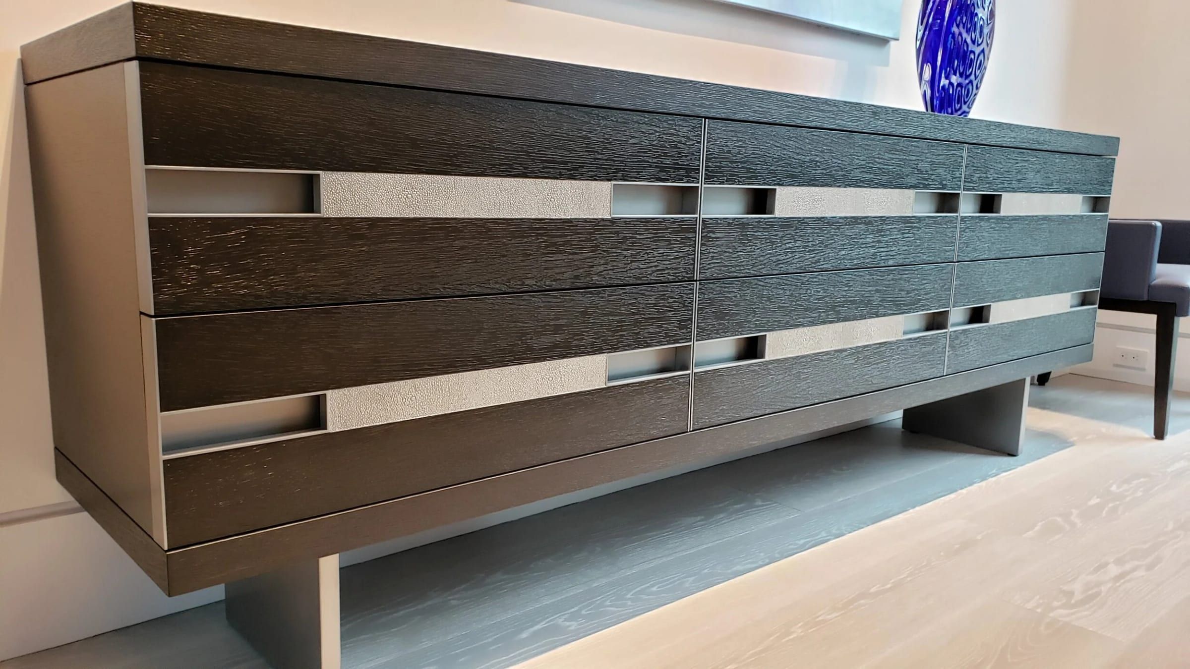 Credenza with metal pull channels, angled view