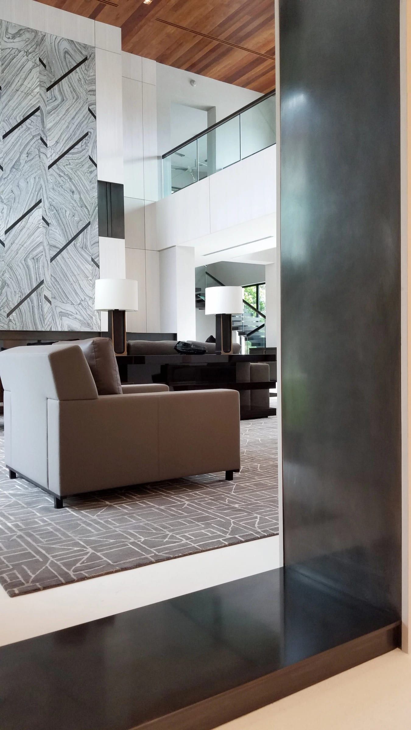 Blackened steel column cladding in a double-height living room
