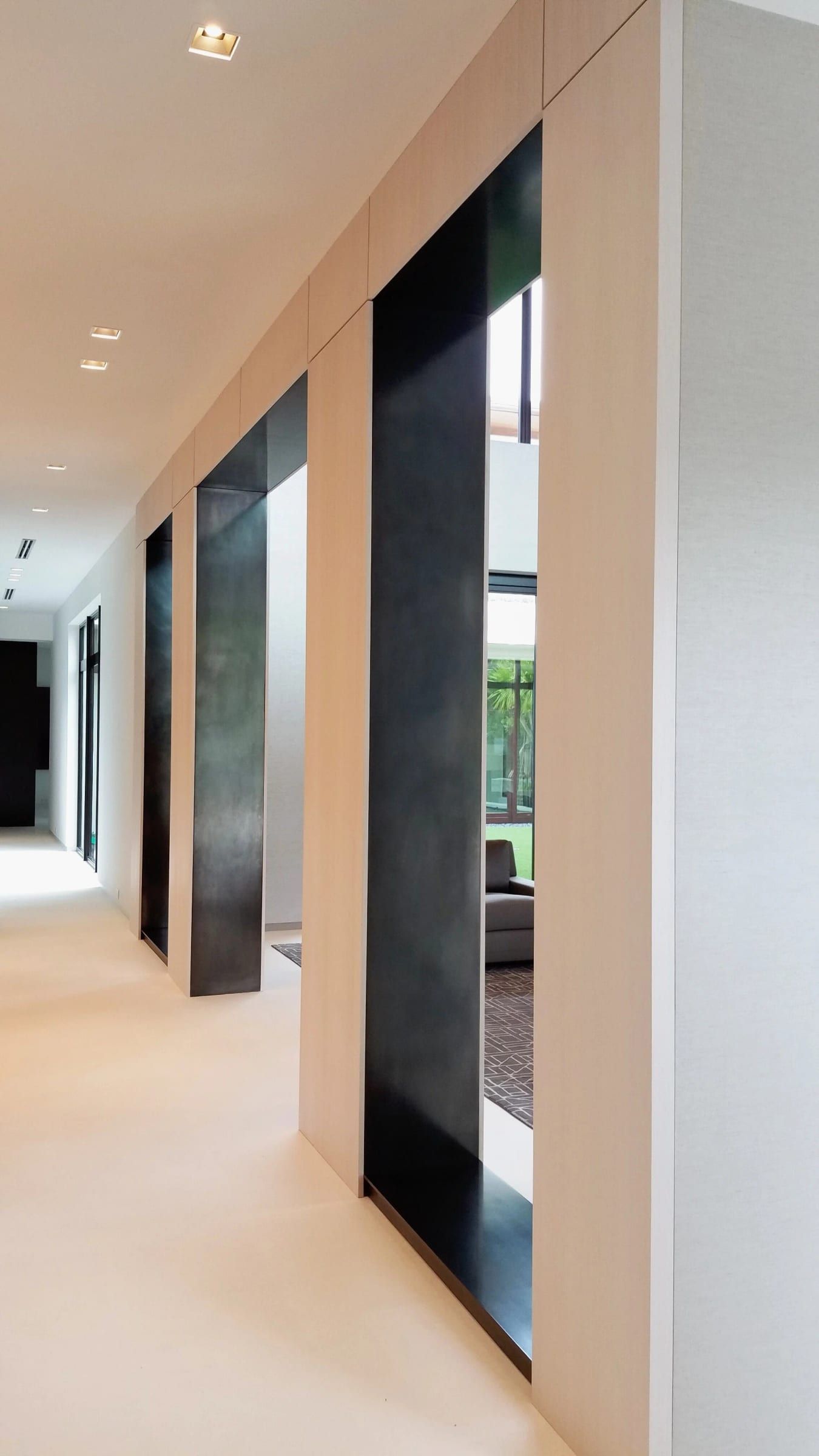 Hallway lined with blackened steel door surrounds
