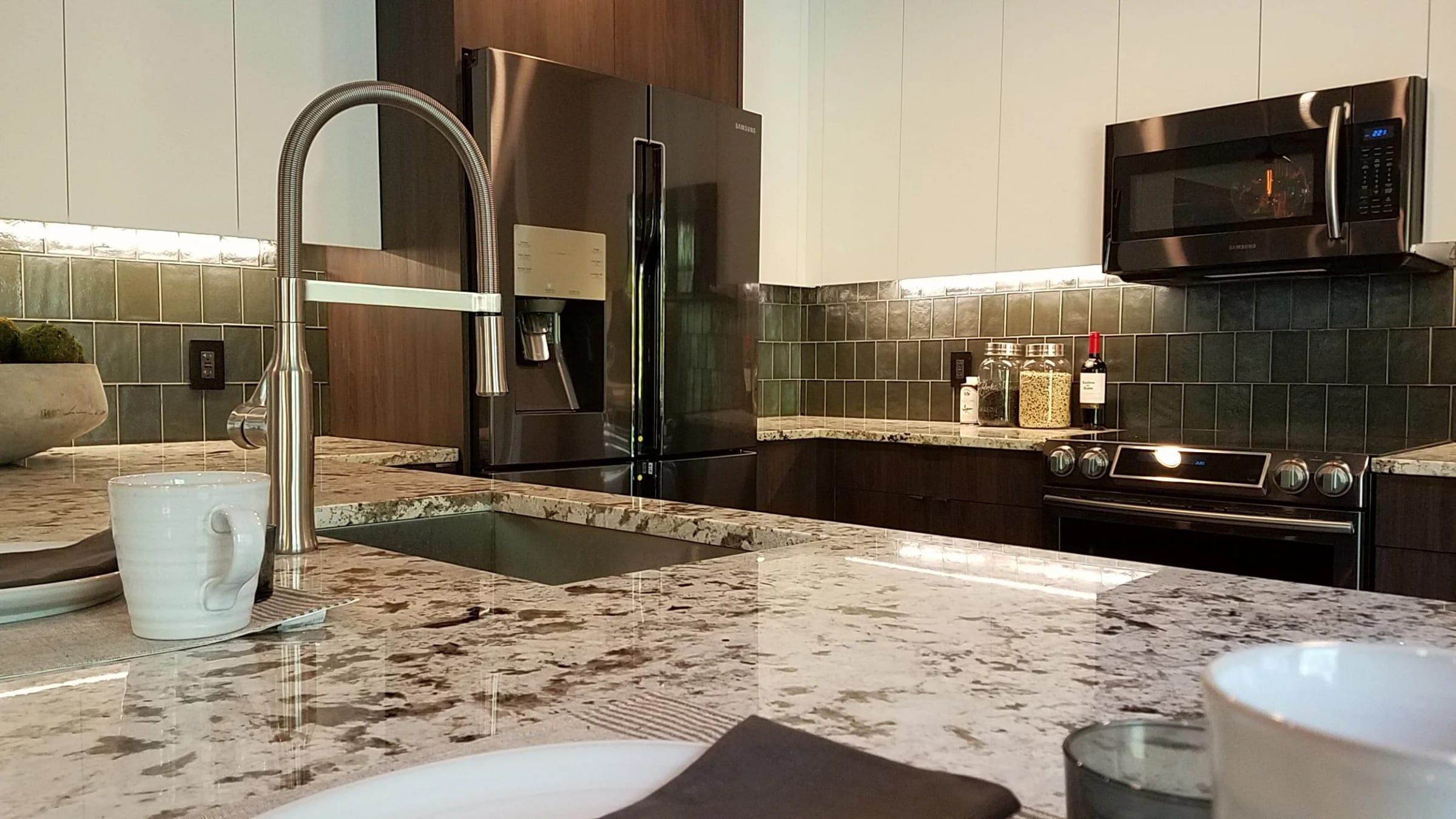 Granite counter and pull-down faucet in a remodeled kitchen