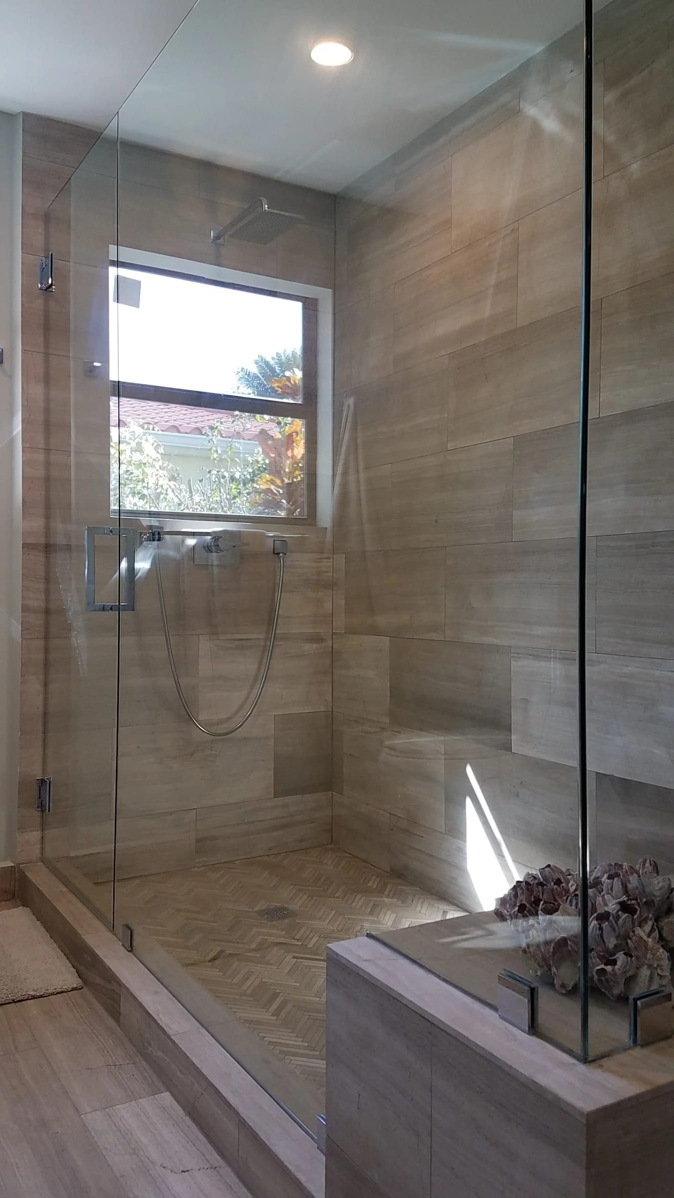 Walk-in glass shower with wood-look tile