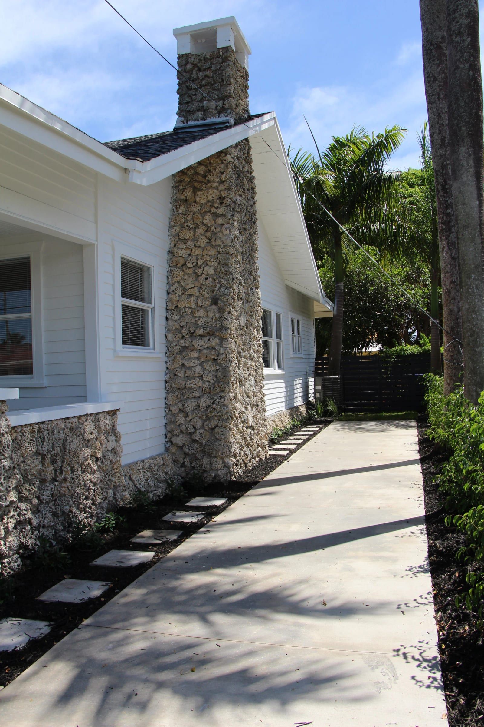 Side path beside a coral stone chimney